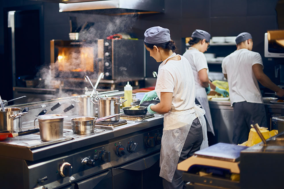 Cooks using restaurant equipment